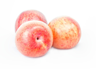 Ripe pink pluots on white background.
