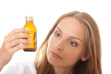 Fototapeta premium woman doctor with medication in glass bottles