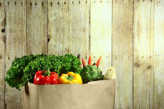 Bag Of Grocery Produce Items On A Wooden Plank