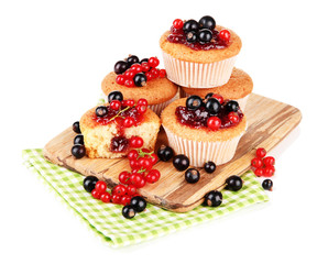 Tasty muffins with berries isolated on white