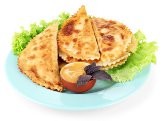 Tasty chebureks with fresh herbs on plate, isolated on white