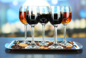 Glasses of liquors with almonds and coffee grains,
