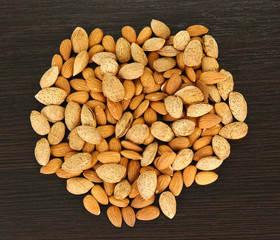 Almond on dark wooden background