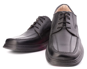 Black glossy man’s shoes with shoelaces