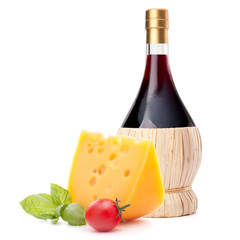 Red wine bottle, cheese and tomato still life
