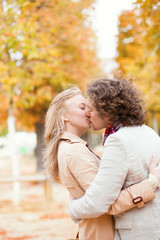 Fototapeta premium Romantic couple kissing on a fall day