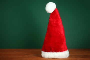Red Santa Hat With Copy Space on Green and Wood Background