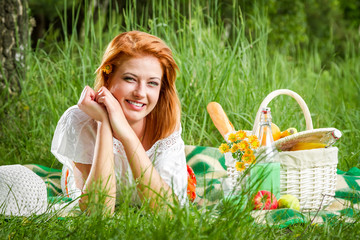 Happy young woman on a summer meadow