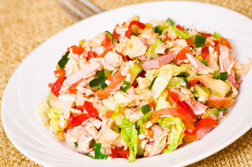 fresh salad with chicken, ham and vegetables