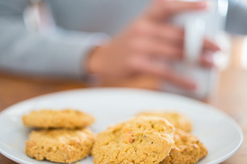Cookies and woman holding a cup