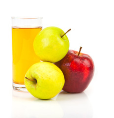 Delicious apple juice in glass and apples isolated on white