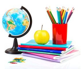 Naklejka premium Globe, notebook stack and pencils.