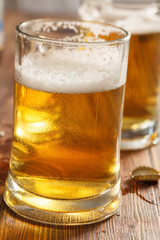 two cold beer glasses on bar or pub desk