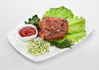 Grilled steak on a white plate