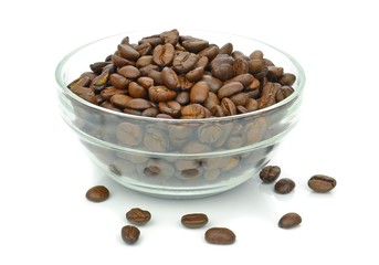 A glass bowl of coffee beans on a white background