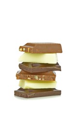 A mixed stack of chocolate chunks on a white background