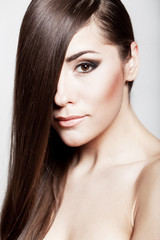 Obraz premium Beautiful young brunette woman with long hair
