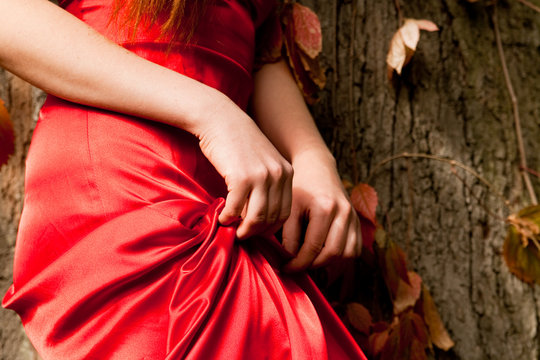 The girl in the red dress holds hands