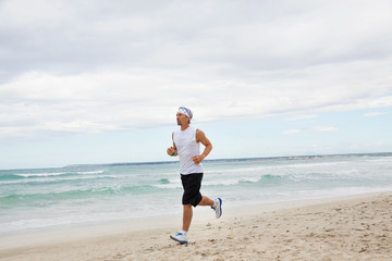 Fototapeta na wymiar erwachsener sportlicher mann jogger am strand