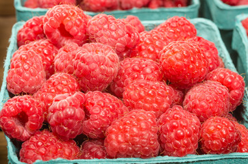 Fresh red raspberries on display at the market