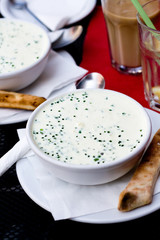 Flavored cheese soup with greens for dinner