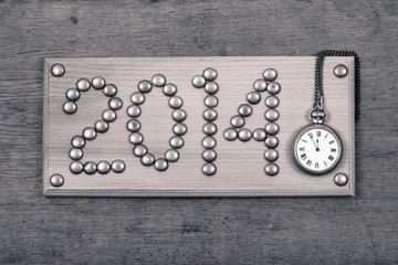 Fototapeta na wymiar Vintage New Year date sign board on wooden background with clock
