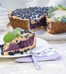 Slice of blueberry pie with mint