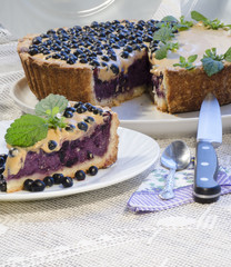 Blueberry pie with mint served with knife and spoon