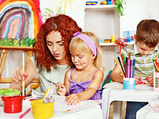 Child painting with mum.