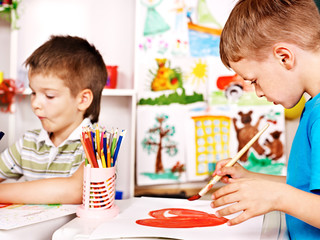Children painting at easel.