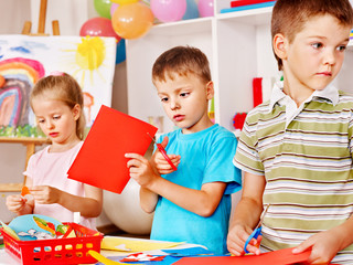 Fototapeta premium Children cutting out scissors paper.