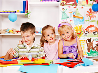 Child cutting out scissors paper.