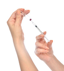 Doctor hands with medical syringe with needle in ampule