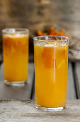 Orange drink on wooden table, selective focus