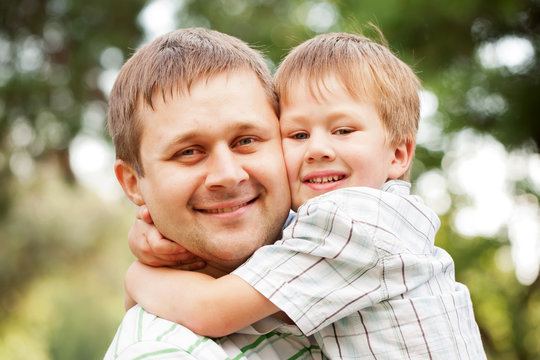 Happy father and son outdoors.