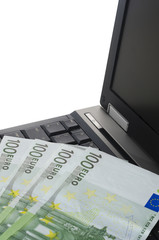 close up of a laptop computer with some euro notes
