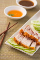 chinese roast pork close up shot served with chilli sauce