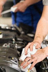 Car mechanic wiping his dirty hands