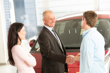 Caucasian couple purchasing a car