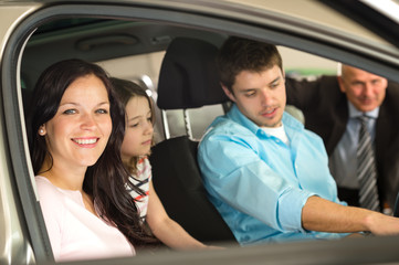 Family sitting in car in retail store