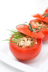 Fresh tomatoes stuffed with tuna salad and bulgur close-up