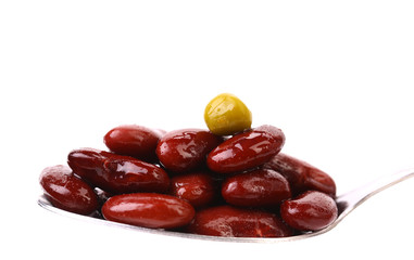 Preserve beans and pea on a spoon.