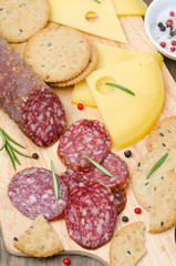 Italian salami, cheese and crackers on a cutting board