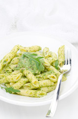 pasta penne with sauce of arugula and peas vertical