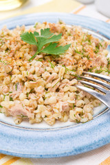 salad with bulgur, tuna and herbs, close-up, selective focus