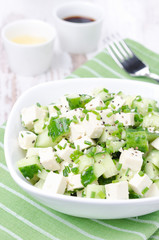 salad with cucumber, tofu, chives and sesame seeds, vertical
