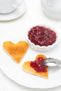 toast in the shape of hearts and berry jam