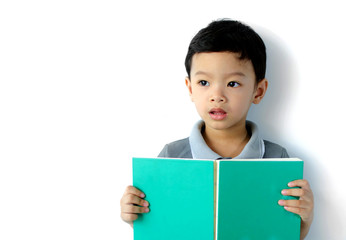 Cute little boy reading a book