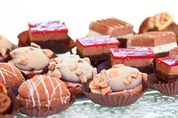 Mixed mini sweet canape desserts on plate. Sweet sushi.