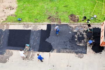 workers laid asphalt on urban road